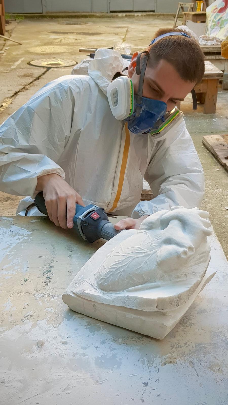 Teodor Popescu carving in his studio